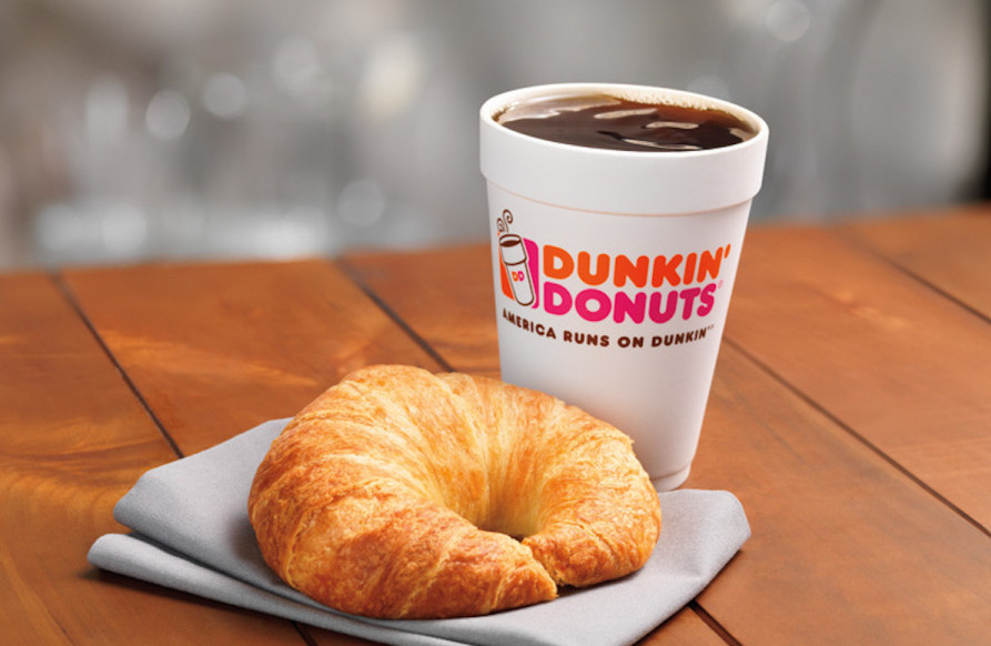 A hot Dunkin' Donuts coffee with a croissant