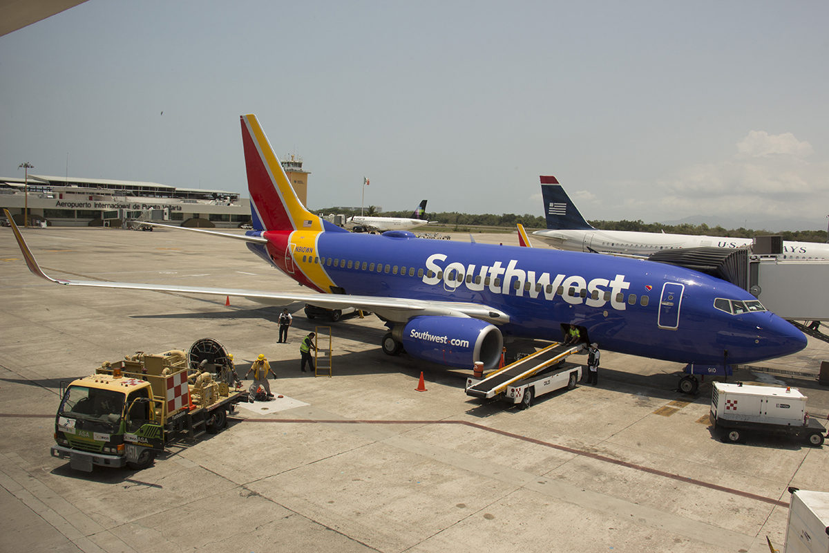 A parked Southwest plane at a gate.