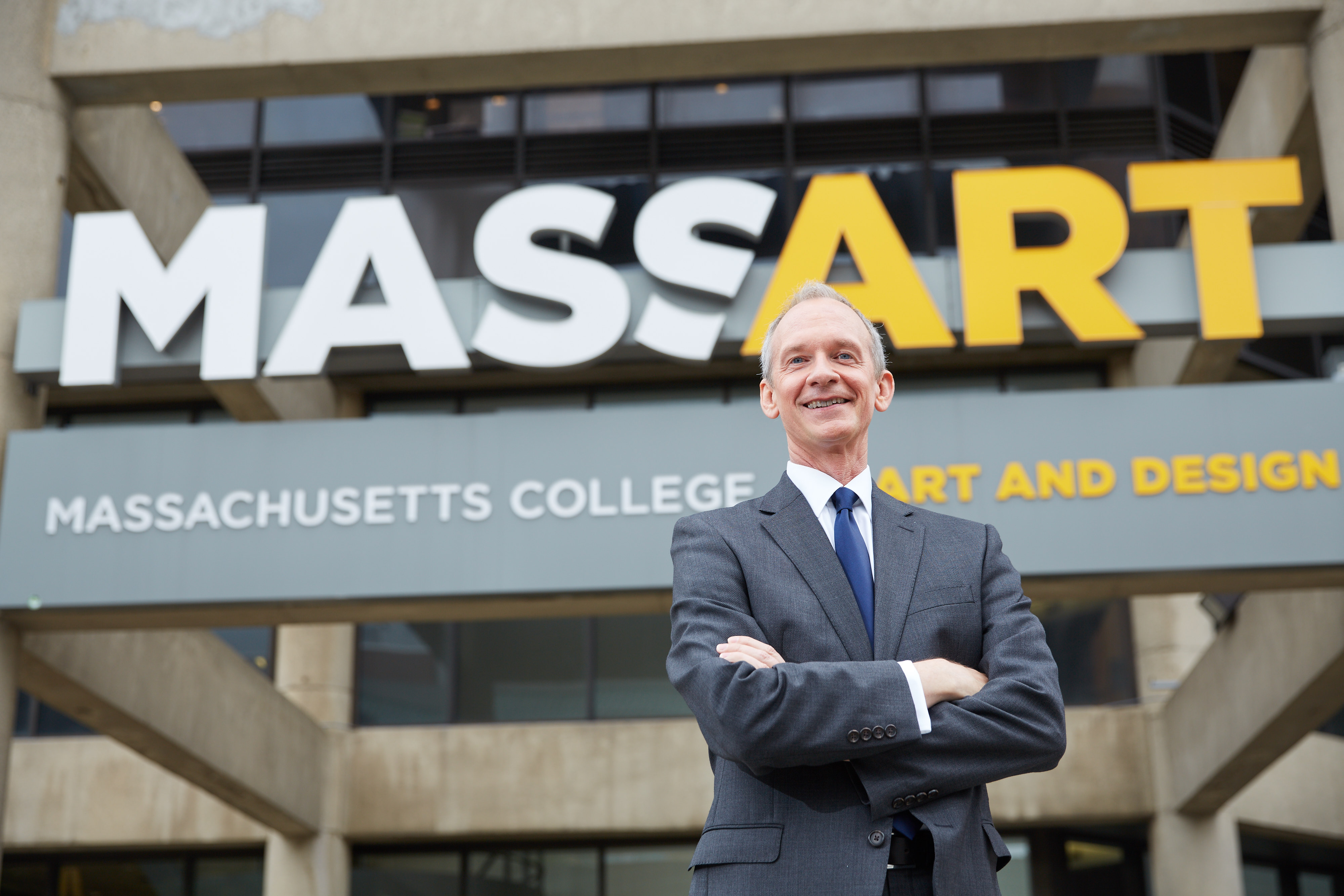 David Nelson in front of the MassArt sign.