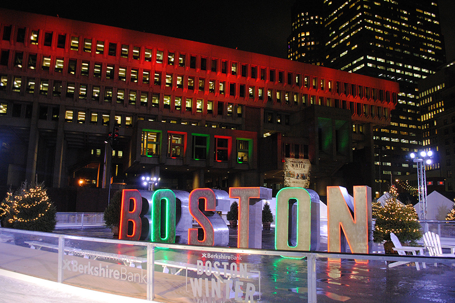 "Boston" in red and green letters on an ice rink in front of City Hall