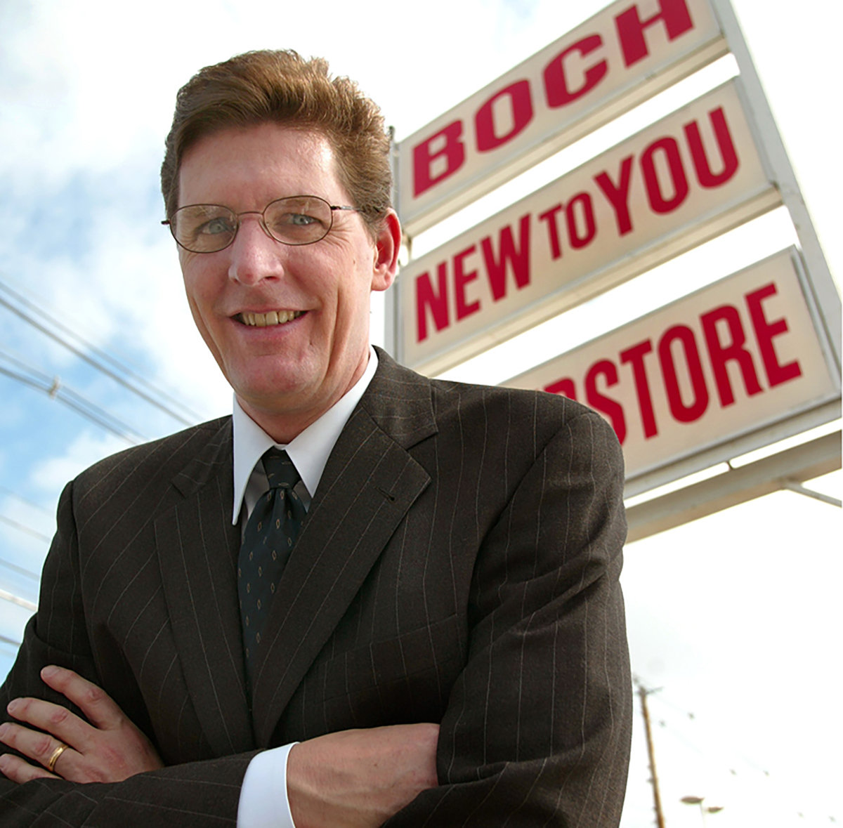 Boch, before his extreme makeover, outside his used car dealership in 2003....