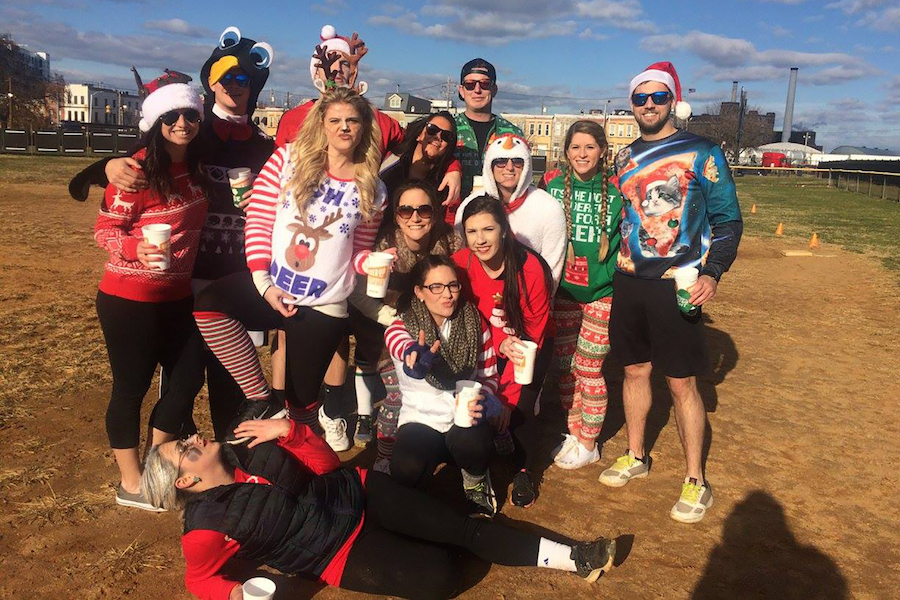 Kickball team members wearing sweaters and holiday gear