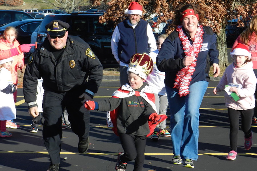 A boy dressed as a king racing a police officer