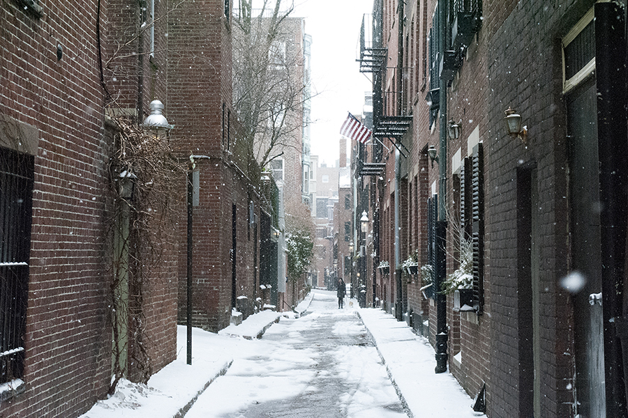 A snowy street lined with brick buildings