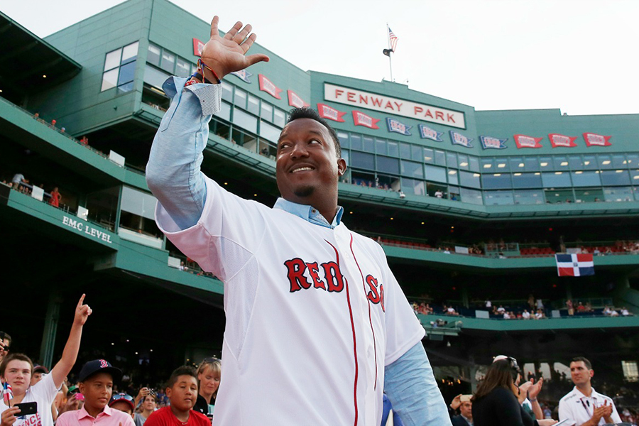 Pedro Martinez smiles and waves in a Red Sox jersey