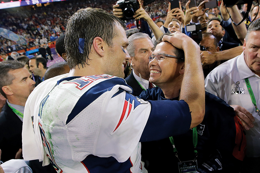 Tom Brady smiles at Alex Guerrero after winning the Super Bowl