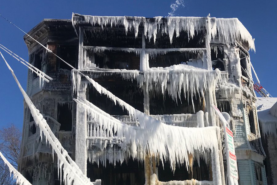 A three-story building covered in ice