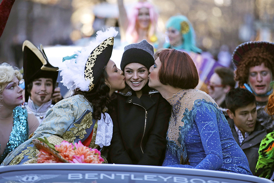 Actress Mia Kunis is kissed by actors dressed in drag during a parade for Kunis in Cambridge, Thursday, Jan. 25, 2018. Kunis was honored as "Woman of the Year" by the Hasty Pudding Theatricals at Harvard University.