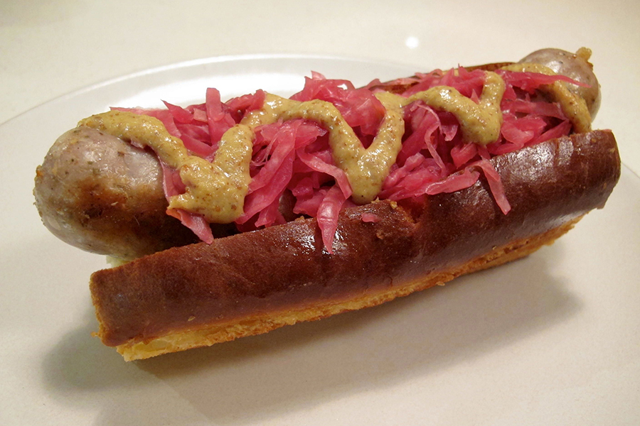 Cheddar bratwurst topped with Hosta Hill Crimson Kraut and grainy mustard from Meadowlark Butcher
