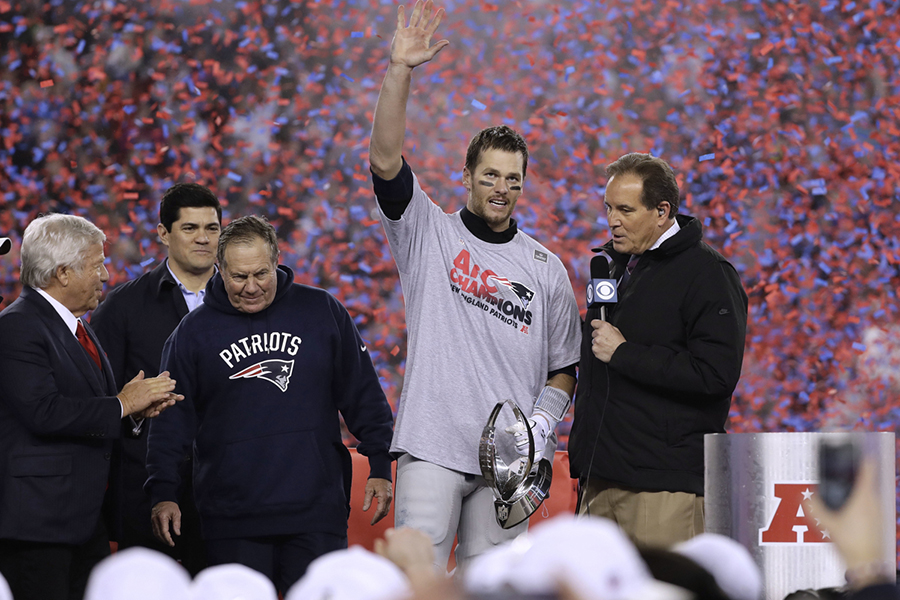 Bill Belichick, Robert Kraft, and Tom Brady receive the Lombardi trophy and are surrounded by confetti