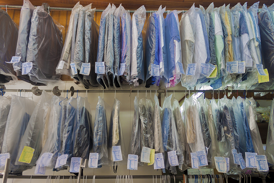 Clothes hang on a dry cleaners' rack