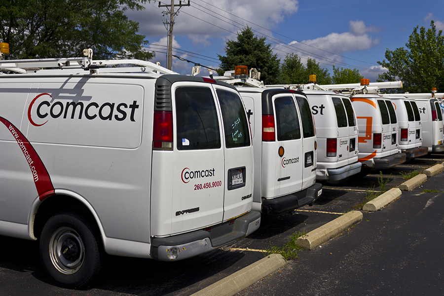 A row of Comcast vans