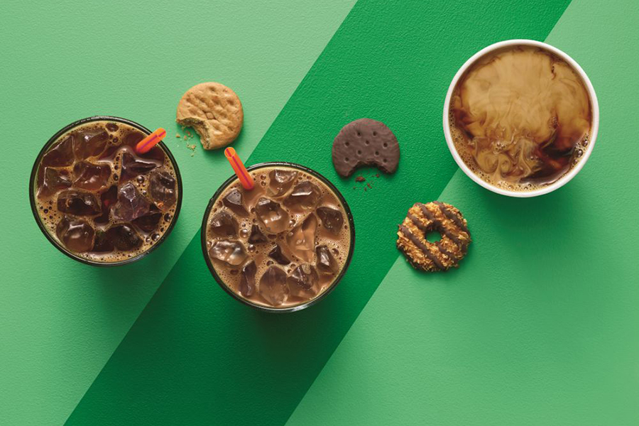An overhead shot of Girl Scout Cookies and Dunkin' Donuts coffees