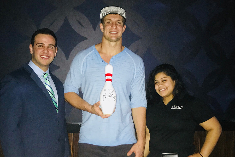 Rob Gronkowski at Kings Seaport on Tuesday Feb. 13 with Kings manager and a server. Gronk is holding a signed bowling pin