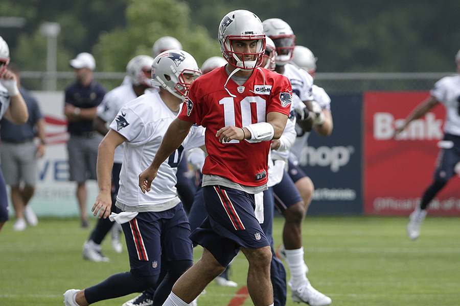 New England Patriots quarterback Jimmy Garoppolo (10) warms up with members of the team during an NFL football practice Tuesday, June 7, 2016, in Foxborough, Mass.