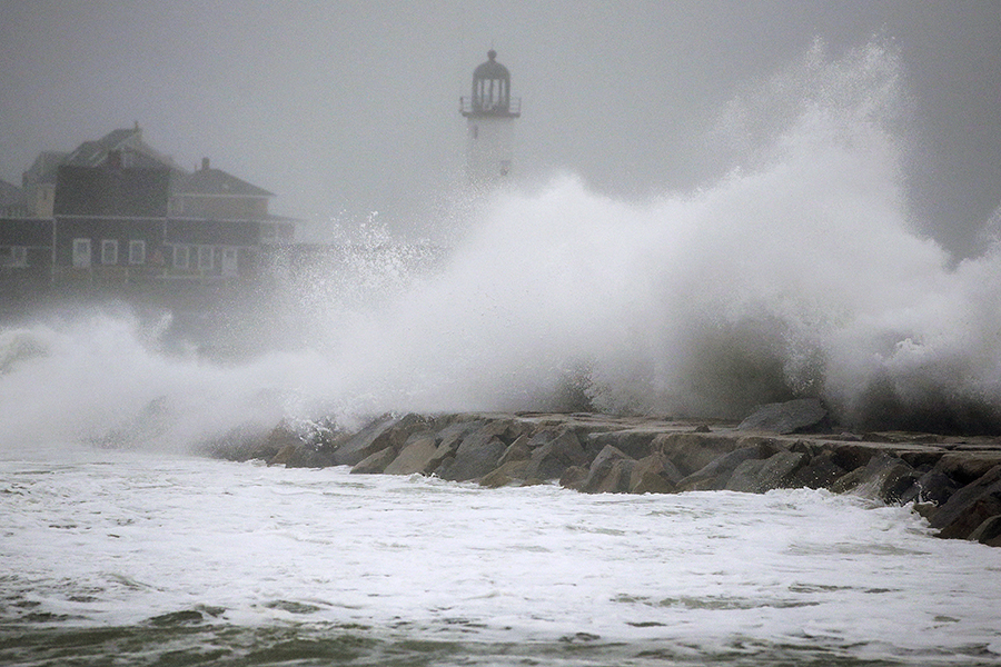 Waves crash against a seawall near the Scituate Lighthouse, Friday, March 2, 2018, in Scituate, Mass. A major nor'easter pounded the East Coast on Friday, packing heavy rain and strong winds as residents from the mid-Atlantic to Maine braced for coastal flooding. 