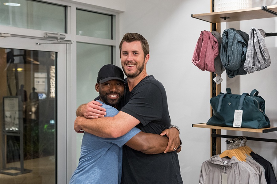 jackie bradley jr and drew pomeranz (red sox players) embrace at the pop-up preview of the lululemon red sox collaboration