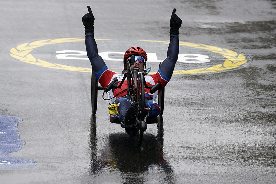 Tom Davis, of the United States, celebrates as he wins the handcycle division of the 122nd Boston Marathon on Monday, April 16, 2018, in Boston.