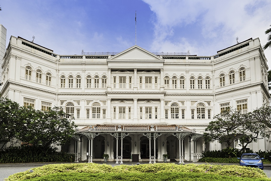 The imposing ornate Victorian facade of the 19th Century Raffles Hotel, iconic symbol of luxury and birthplace of the Singapore Sling cocktail. ProPhoto RGB profile for maximum color fidelity and gamut.