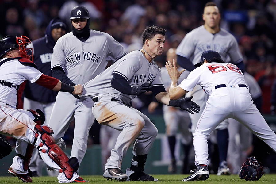 New York Yankees' Tyler Austin, center, rushes Boston Red Sox relief pitcher Joe Kelly, right, after being hit by a pitch during the seventh inning of a baseball game at Fenway Park in Boston, Wednesday, April 11, 2018.
