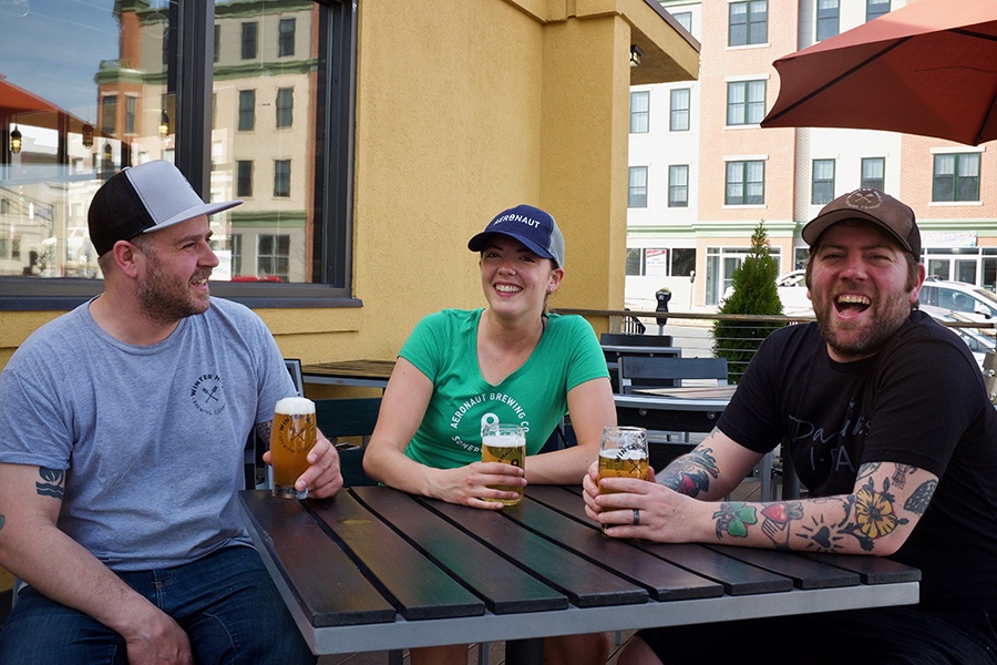 Brewers from Winter Hill and Aeronaut enjoy the first pints of Somerville Porchbeer. Try it this weekend during PorchFest