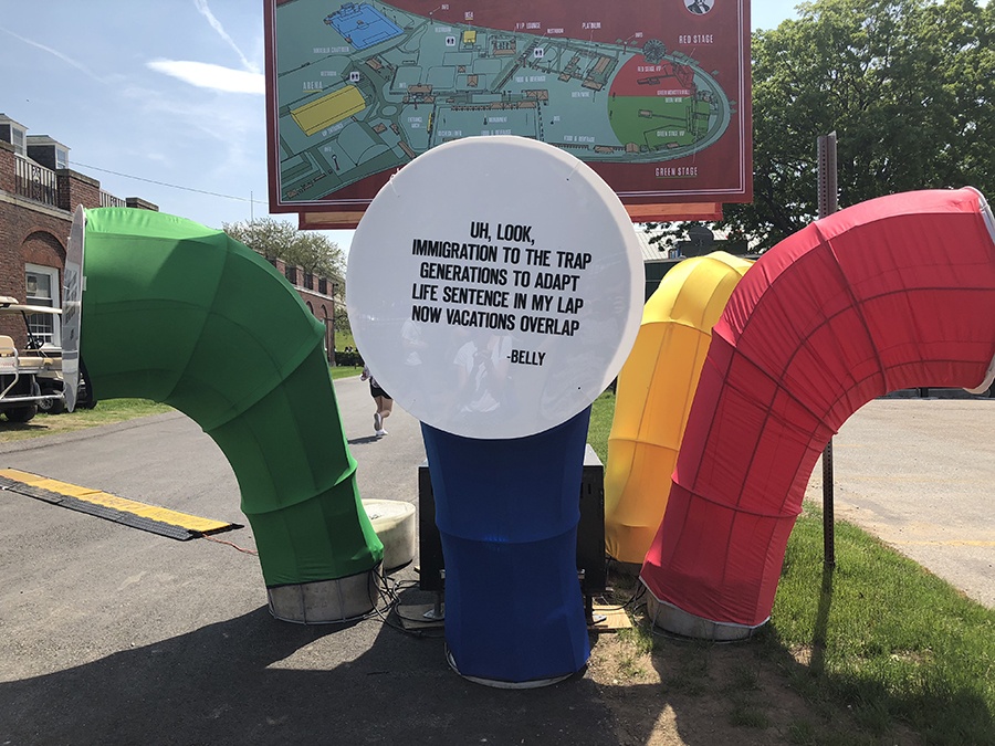 Multi-colored tubes with song lyrics and a map of the festival