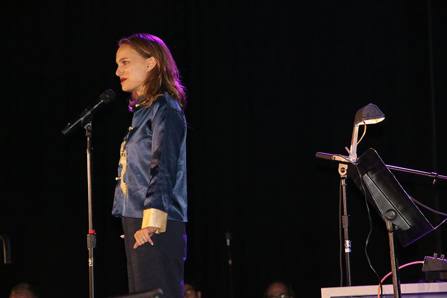 Natalie Portman stands at the microphone