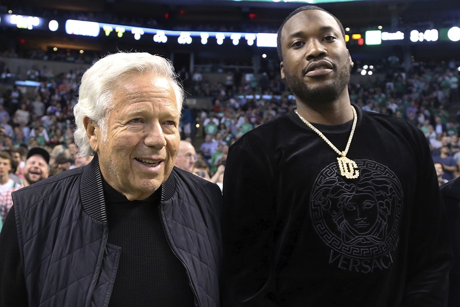Rapper Meek Mill, right, stands with New England Patriots football team owner Robert Kraft at their seats for Game 2 of an NBA basketball second-round playoff series between the Boston Celtics and the Philadelphia 76ers, Thursday, May 3, 2018, in Boston. 