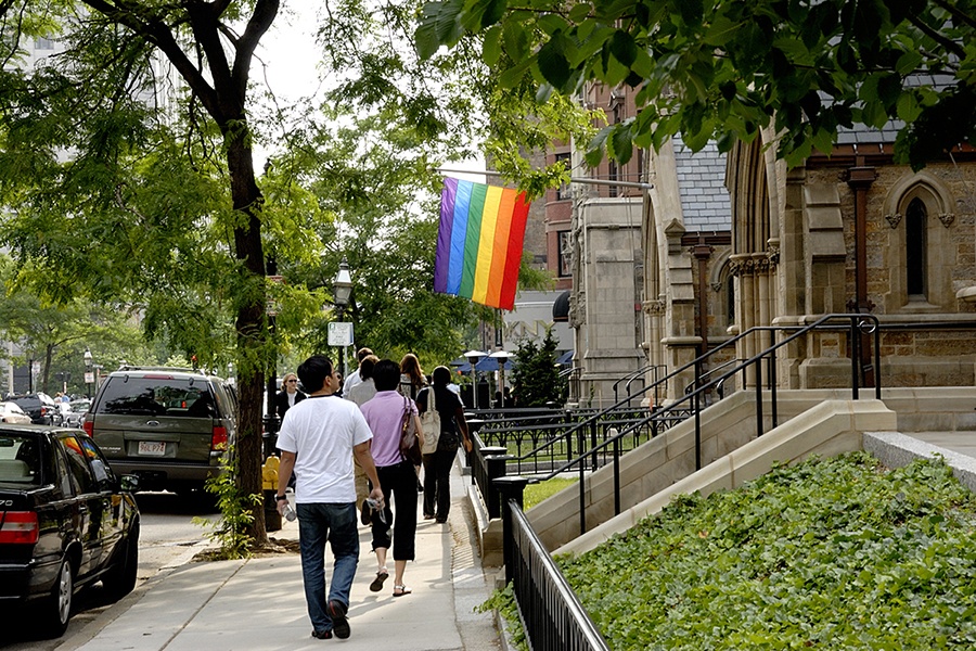 A rainbow flag hangs on a street in Boston