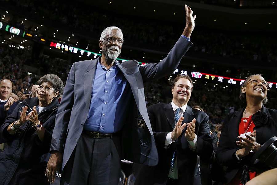 Boston Celtics great Bill Russell waves to the crowd during a tribute in his honor in the second quarter of an NBA basketball game between the Celtics and the Milwaukee Bucks in Boston, Friday, Nov. 1, 2013. 