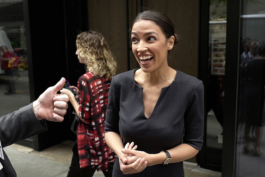Alexandria Ocasio-Cortez, the winner of a Democratic Congressional primary in New York, reacts while talking to the media, Wednesday, June 27, 2018, in New York. Ocasio-Cortez, 28, upset U.S. Rep. Joe Crowley in Tuesday's election. (