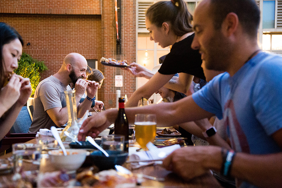 Guests digging into a pig roast at Pagu