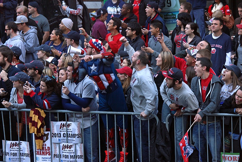 Red Sox fans cheer the team during the 2013 World Series victory parade in Boston