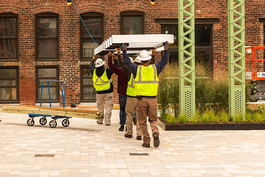 Contractors install the sign at the soon-to-open Trillium restaurant in Fort Point