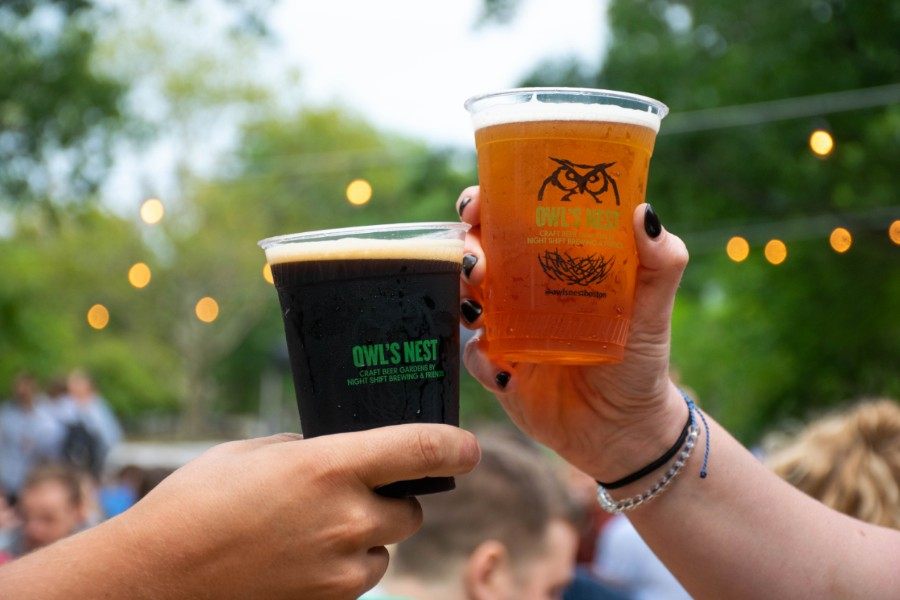 Two plastic pints of beer "cheers" at Night Shift Owl's Nest beer garden