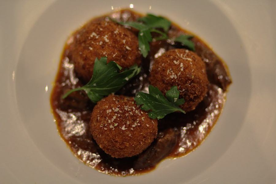 Fontina cheese arancini with braised oxtail ragu at the Winnisimmet Lounge