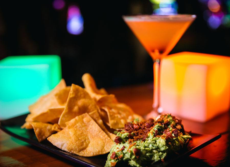 A drink and chips on the glowing bar at Bit Bar Salem