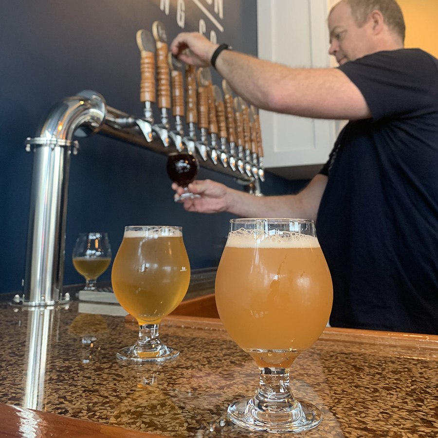 Brewer Mike Estey pours a beer at Distraction Brewing Co. during opening weekend, on Sunday, Oct. 20.