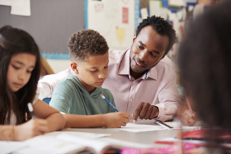 teacher working with student