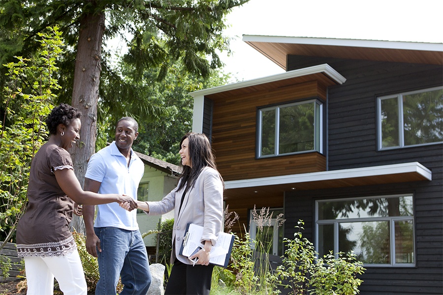 real estate agent showing couple a house