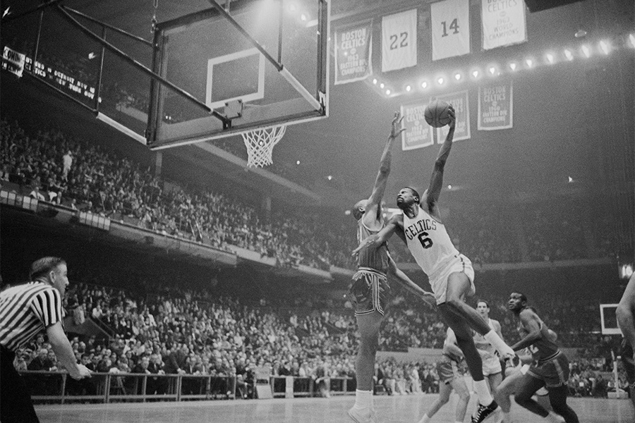 Bill Russell leaping to the basket
