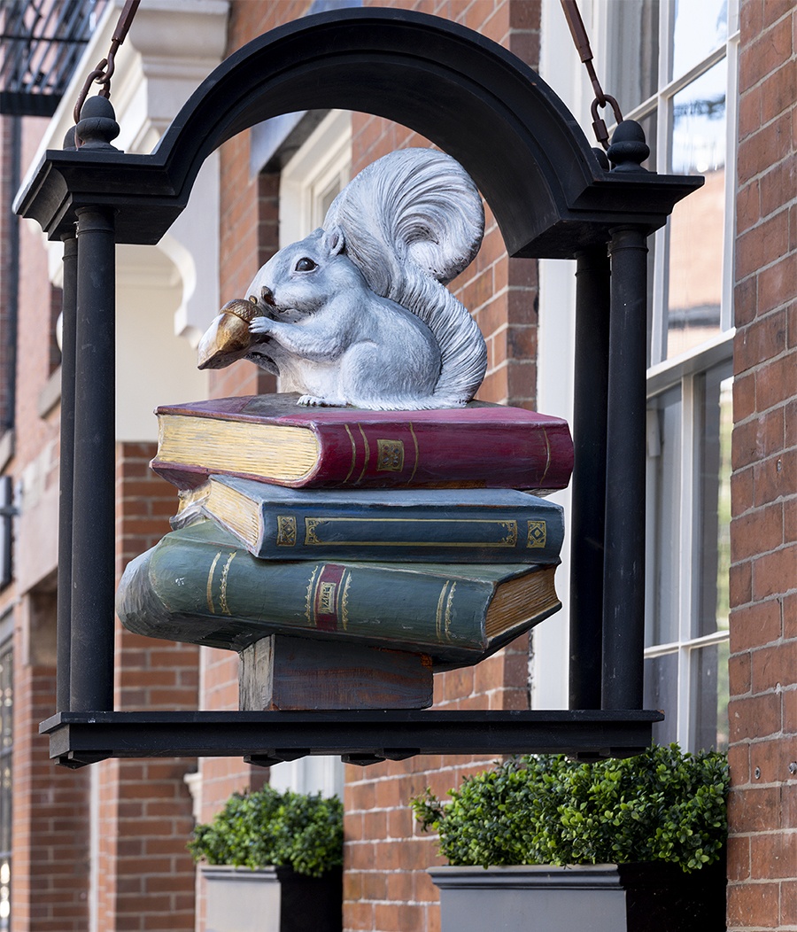 a carving paige the squirrel outside beacon hill books