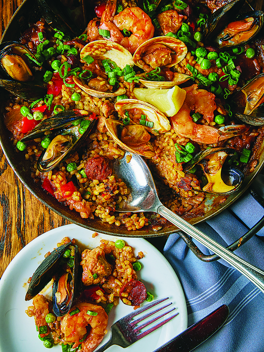 Overhead view of a big pan of seafood-packed paella.
