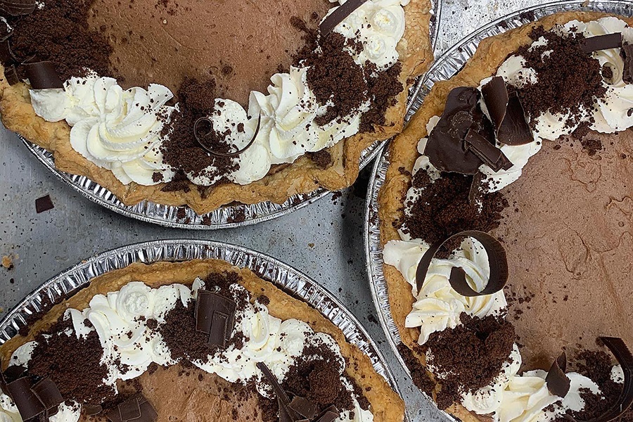 Overhead view of three French silk pies with a whipped cream garnish.