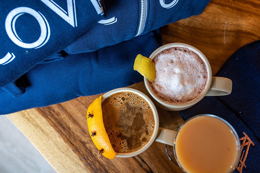 An overhead shot of three warm cocktails in mugs.