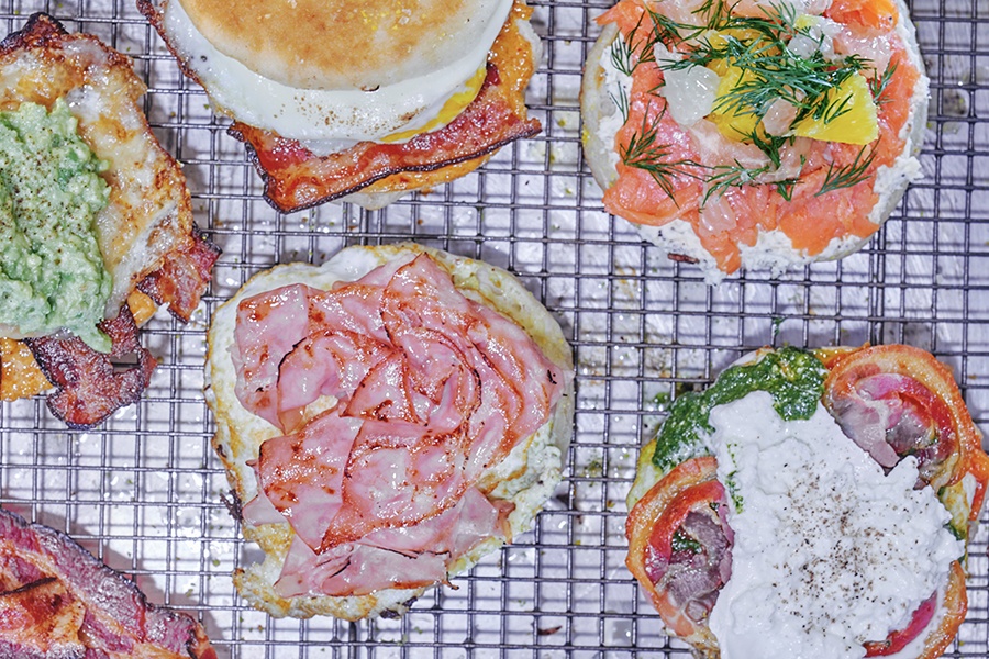 Overhead view of a variety of open-faced breakfast and lunch sandwiches.