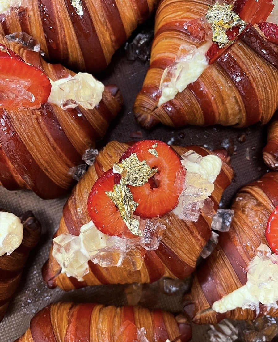 Croissants with a strawberry, champagne mousse, and gold flake topping.