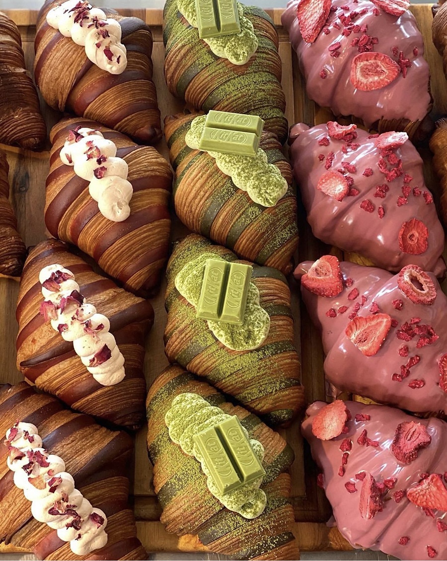 Three columns of elaborate croissants, each column with a different topping.