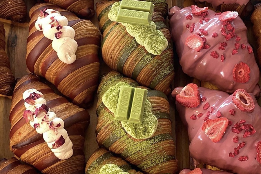 Three columns of elaborate croissants, each column with a different topping.