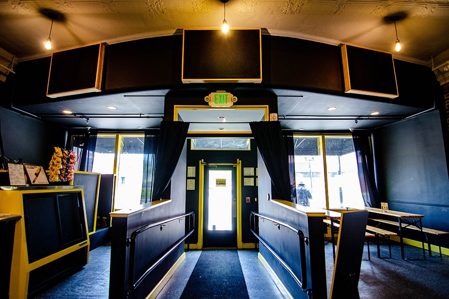 A restaurant interior features black surfaces with yellow accents.